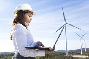 Women on computer with Wind Turbines in background