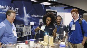 Teacher with students at a science fair