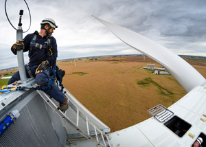 Person sitting on top of windmill