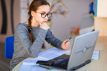Girl on her laptop doing e-learning