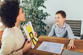 Young teacher working with young happy student