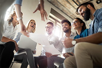 Group of happy professionals talking and laughing